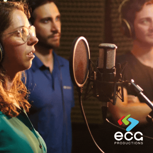 A White woman with glasses and two other performers engage in an Group Looping ADR session, perfecting dialogue for post-production audio refinement.